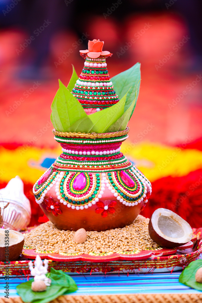 Indian wedding ceremony : decorative coper kalash with green leaf and coconut