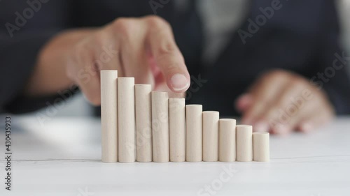 Close up The wooden bars are arranged like a ladder to success. Lying on a wooden table by the window, ideas for running a successful planned business are profitable.