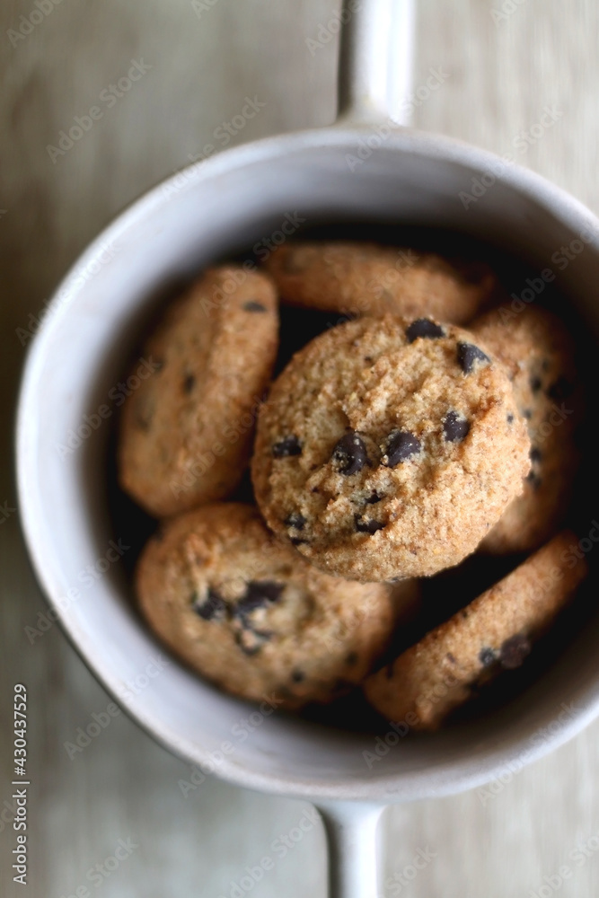 Bowl of chocolate chip cookies on wooden table. Flat lay. Bowl of chocolate chip cookies on wooden table. Flat lay.