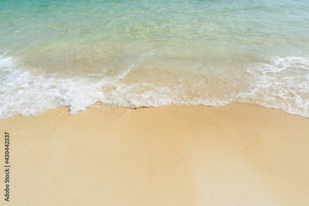 Soft wave of sea on empty sandy beach Background with copy space.