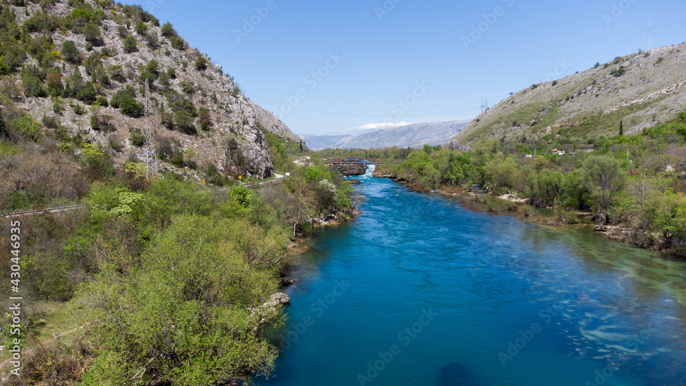 Aerial drone view of river in canyon. Mountain river flowing, view from above. Neretva river in Bosnia and Herzegovina.