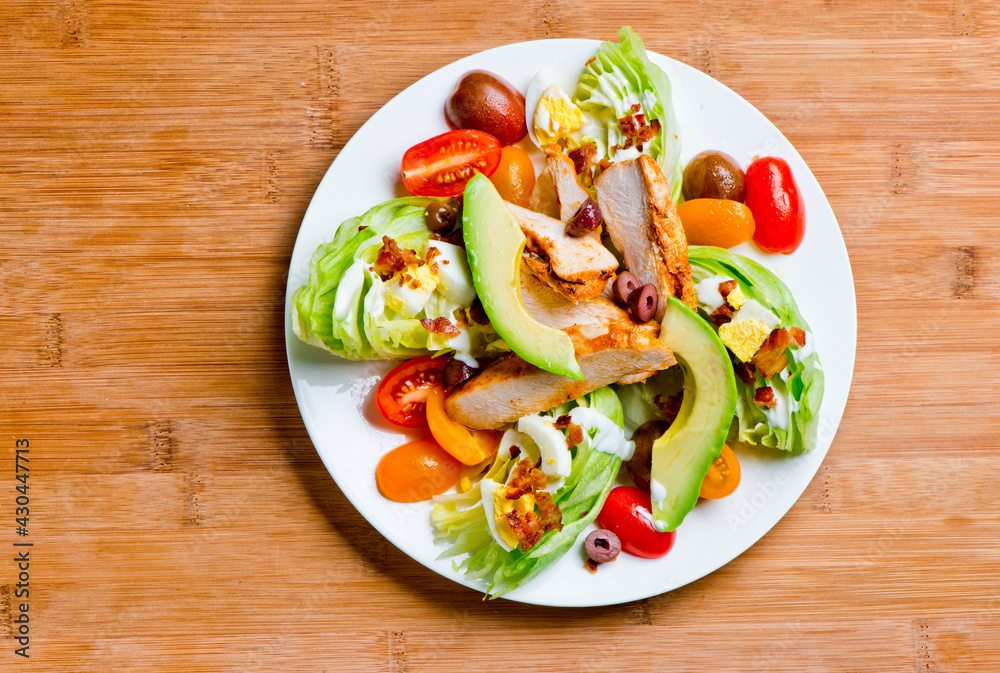Avocado salad. Classic American salad with iceberg lettuce, blue cheese dressing, red onions, bacon lardons, Parmesan cheese, olive oil, lemon juice, salt and pepper. A Fine dining restaurant classic.