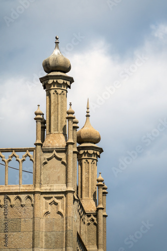 The walls and towers of the old palace on the background of a cloudy sky