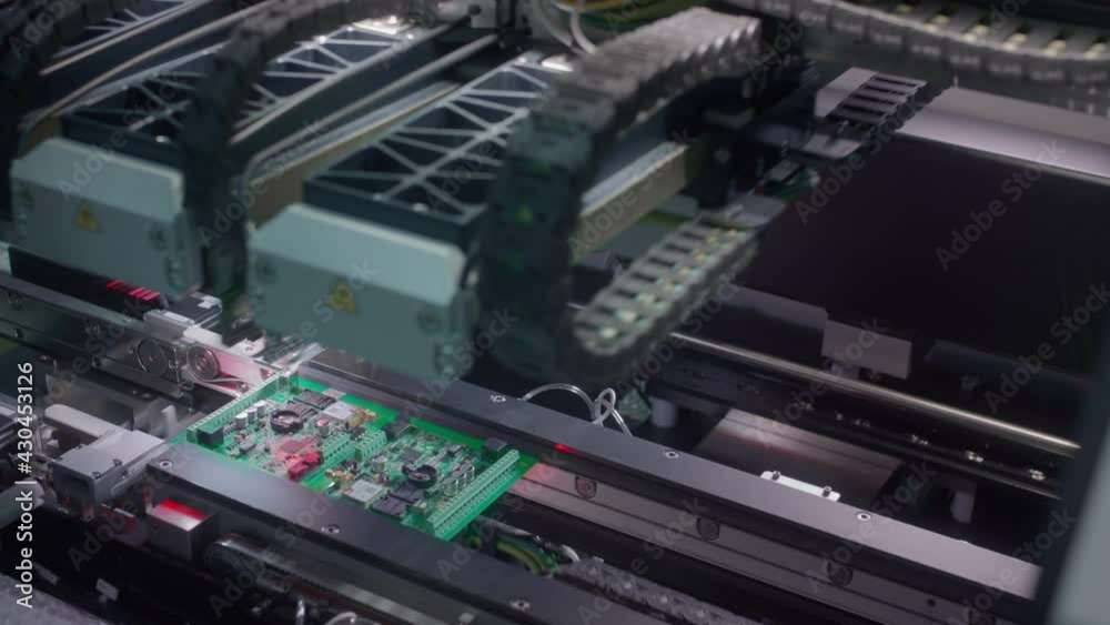 The fourth industrial revolution. Electronic circuit board production. Automated Circut Board machine Produces Printed digital electronic board. Electronics contract manufacturing. High-tech The fourth industrial revolution. Electronic circuit board production. Automated Circut Board machine Produces Printed digital electronic board. Electronics contract manufacturing. High-tech