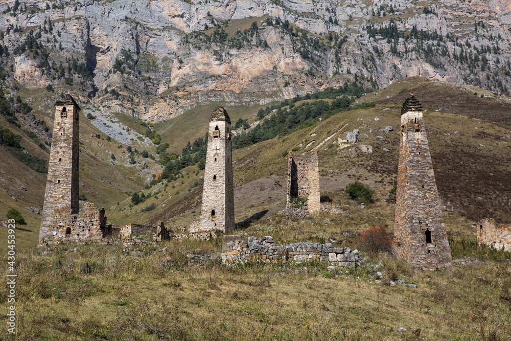 Landscape autumn view of medieval ancient stone battle tower complex in the mountains of Ingushetia, Russia