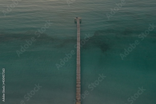 Sunrise aerial Boat dock in Alcudia Beach. Transparent green - turquoise water, 
