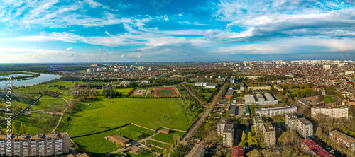 aerial panorama of the western outskirts of the city of Krasnodar near the Kuban River in the spring end of the day before sunset