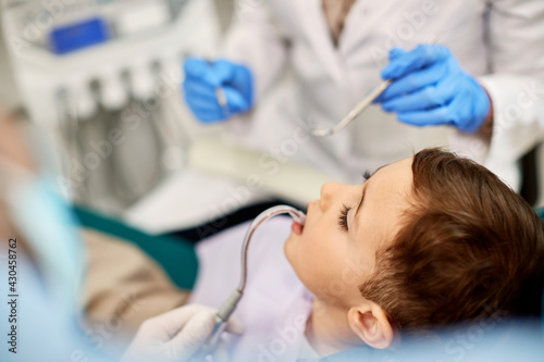 Close-up of child during dental examination at dentist s office.