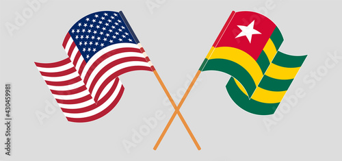 Crossed and waving flags of the USA and Togo