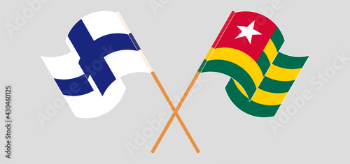 Crossed and waving flags of Finland and Togo