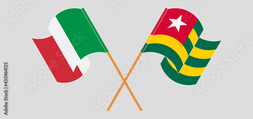 Crossed and waving flags of Italy and Togo