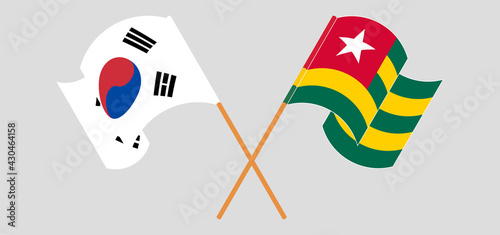 Crossed and waving flags of South Korea and Togo