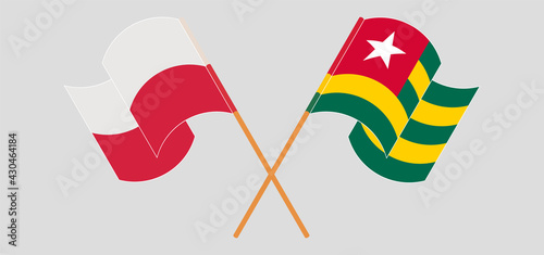 Crossed and waving flags of Poland and Togo