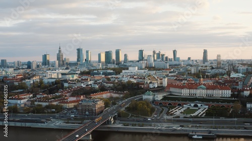 Aerial view of Warsaw, Capital city of Poland. City skyline with beautiful clouds in the background. Vehicles running on the bridge. Busy street. The shot is taken during the morning. Skyscrapers