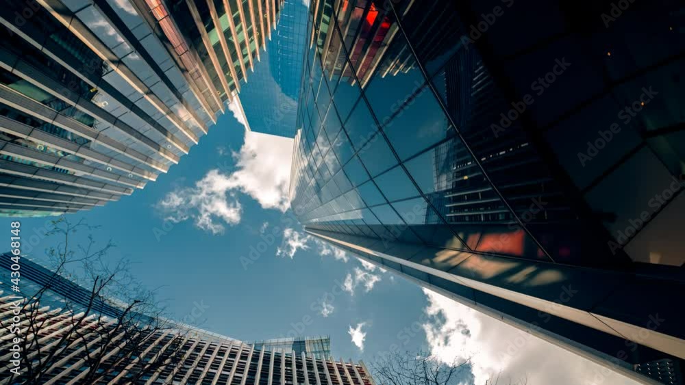 Bottom-up rotating timelapse of important and futuristic skyscrapers in the financial center of a major city