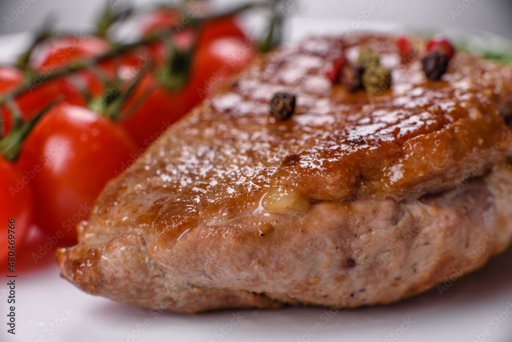 Baked duck breast with herbs and spices on a dark concrete background Baked duck breast with herbs and spices on a dark concrete background