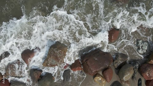 Sea waves crashing against the stones on the beach