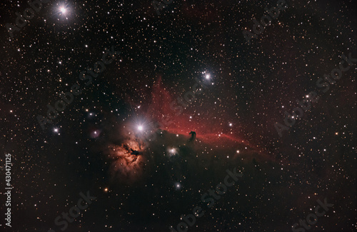 flame and horse head nebula in the orion constellation surrounded by h alpha dust in deep space taken with modified dslr camera photo