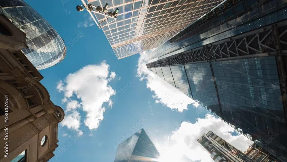 Bottom-up rotating timelapse of important and futuristic skyscrapers in the financial center of a major city
