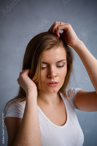 Close up portrait of a beautiful young woman. Emotional photo of a girl. Dressed in a white t-shirt