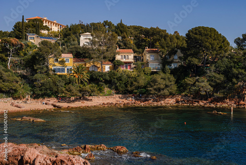Mediterranean beach of the riviera in France. In a small cove of the Cote d'Azur, the sumptuous villas of the residents have a view on the sea.