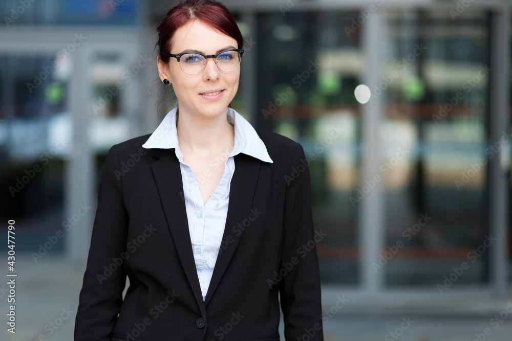 Confident young female manager outdoor in a modern urban setting