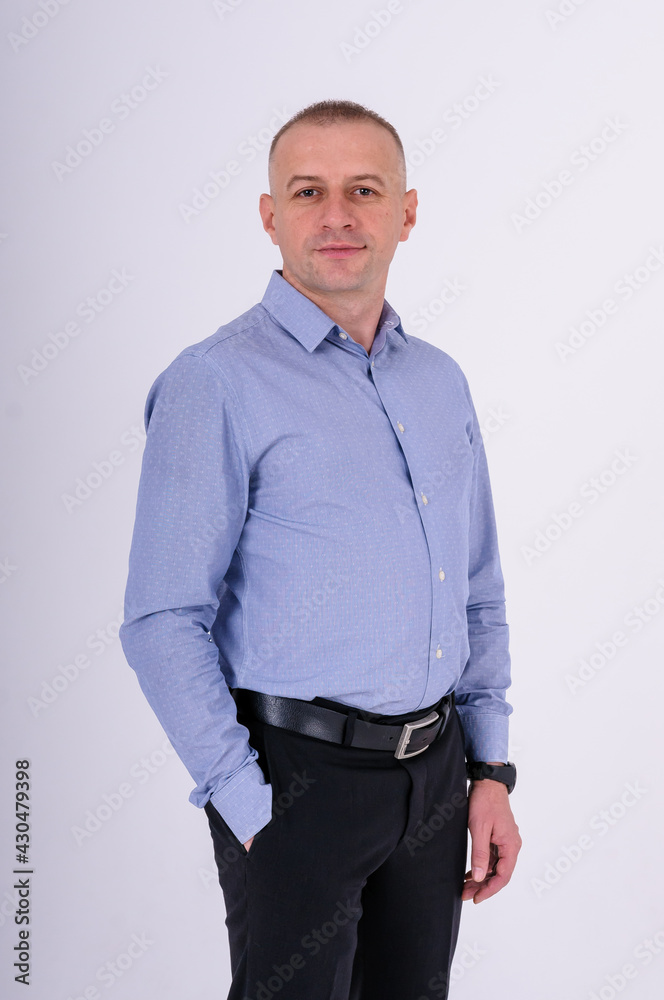 Man in blue shirt and black trousers on white background Man in blue shirt and black trousers on white background