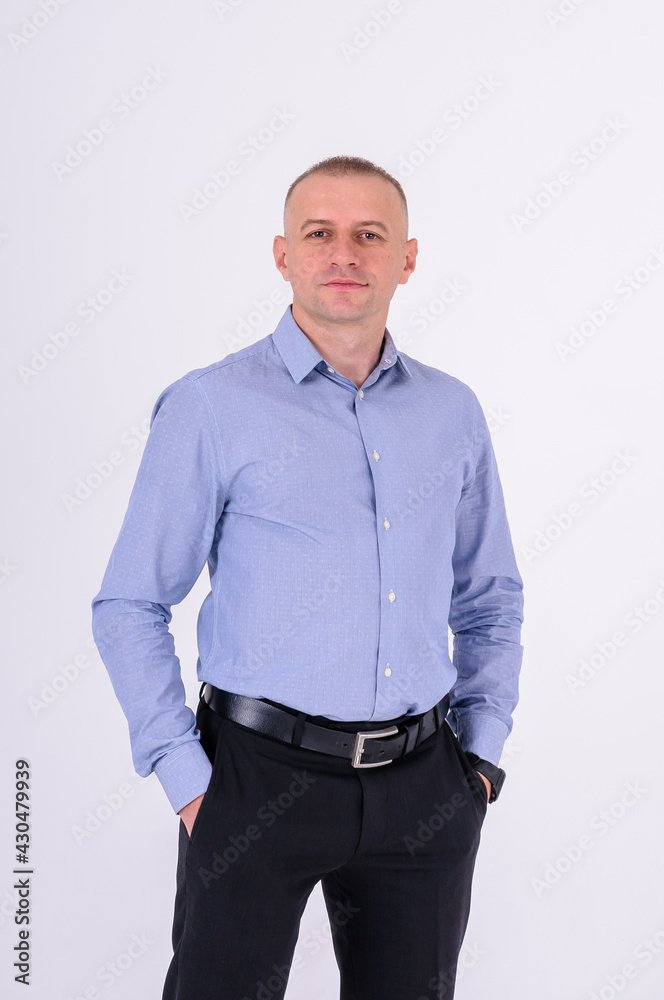Fototapeta premium Man in blue shirt and black trousers on white background