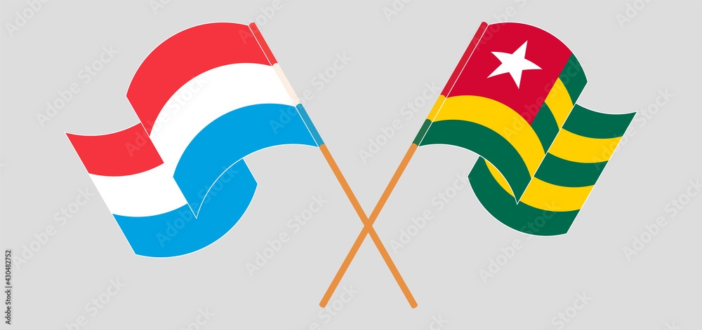 Crossed and waving flags of Luxembourg and Togo Crossed and waving flags of Luxembourg and Togo