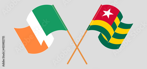 Crossed and waving flags of Ireland and Togo