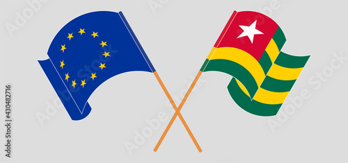 Crossed and waving flags of the European Union and Togo