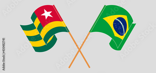Crossed and waving flags of Togo and Brazil
