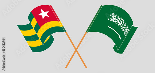 Crossed and waving flags of Togo and the Kingdom of Saudi Arabia