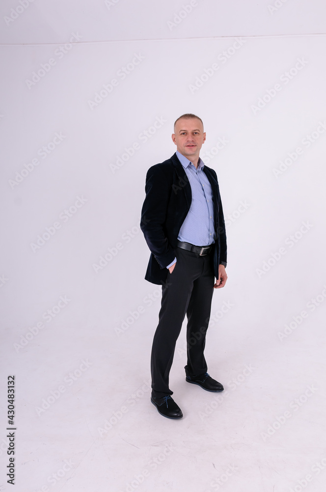 Man wearing a blue shirt, black pants and a blue jacket on a white background Man wearing a blue shirt, black pants and a blue jacket on a white background