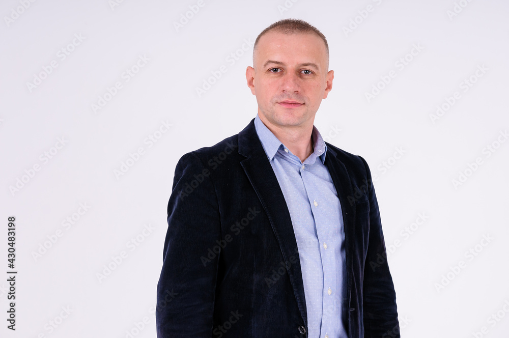 Fototapeta premium Man wearing a blue shirt, black pants and a blue jacket on a white background