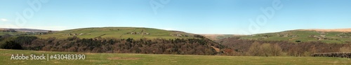 wide panoramic view of the valley above hardcastle crags in calderdale west yorkshire with pecket well and shackleton visible on surrounding hills