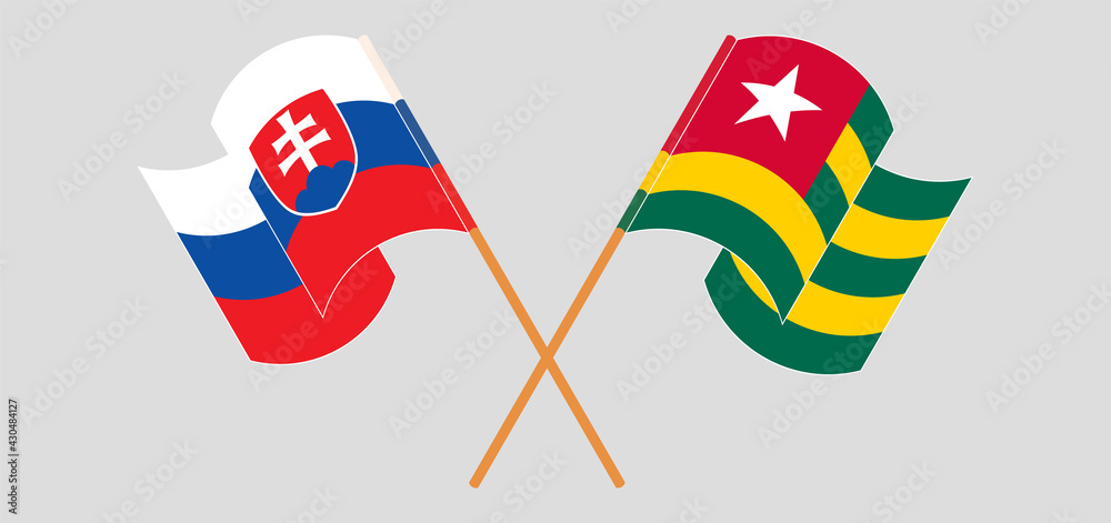Crossed and waving flags of Slovakia and Togo