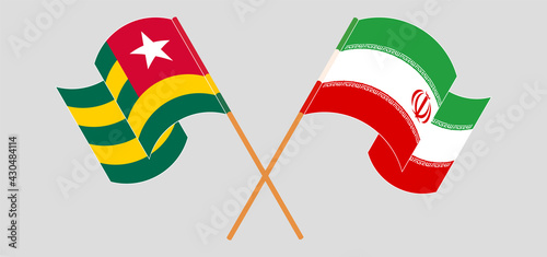Crossed and waving flags of Togo and Iran