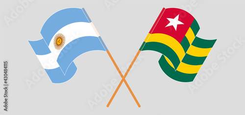Crossed and waving flags of Argentina and Togo