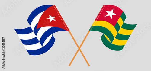 Crossed and waving flags of Cuba and Togo