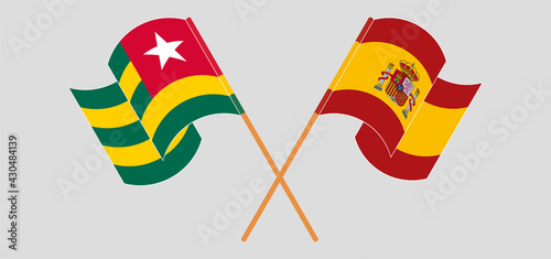 Crossed and waving flags of Togo and Spain