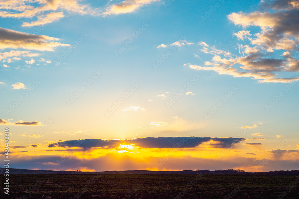 Sunset in the village on the field.