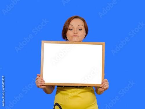 young woman holding a blank board