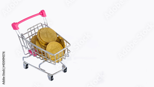 Bitcoin coin in a shopping cart on a white background, stock market concept.