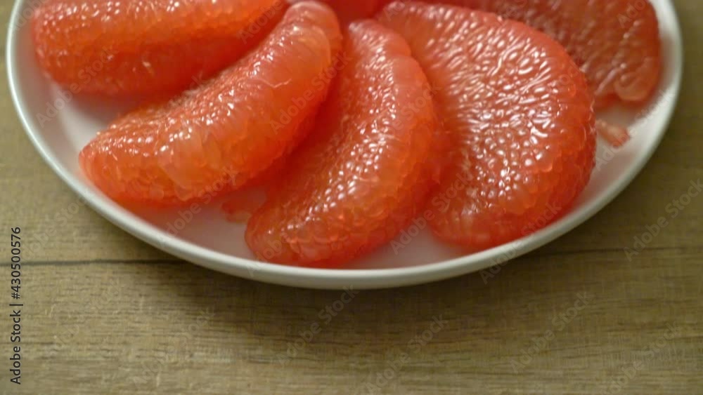 fresh red pomelo fruit or grapefruit on plate fresh red pomelo fruit or grapefruit on plate