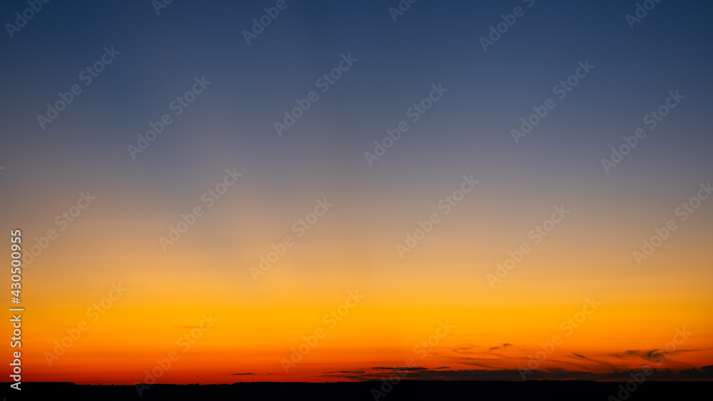 Vibrant and colorful minimalistic landscape. Scenic view of the dramatic sky during sunset. Empty place for text