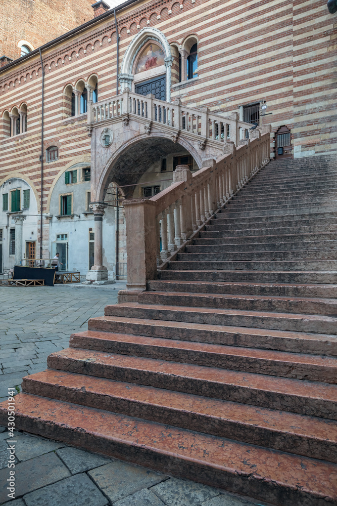 Verona, Italy, 07.04.2019: view of Torre dei Lamberti historical square and building, stairs following to the city tallest tower that was built by the Lamberti family in 1172