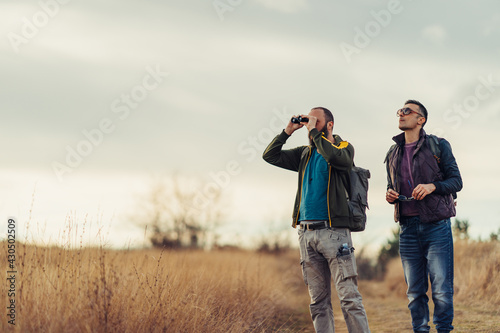 Friends explore nature with binoculars