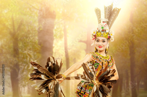 Asian woman dancing East Kalimantan traditional dance (Giring-Giring dance) photo