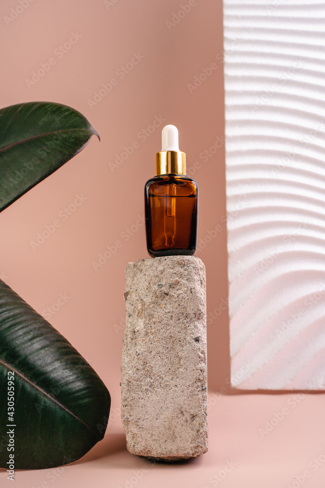 The bottle of Essence is on the pedistal. Lotion on a Beige background. Cosmetics for skin health. Aromo Oil. Serums with vitamin C. Unisex cosmetics. Mockup. 